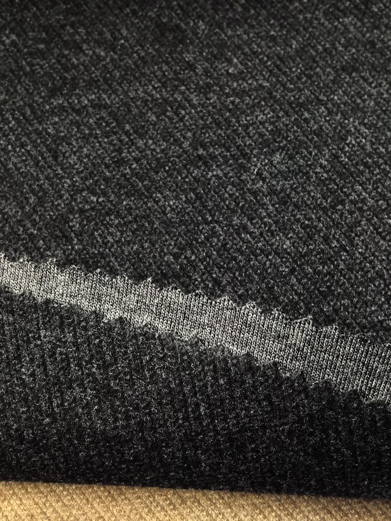Fine-Gauge Soft-Brushed Twill Snow-Speckled Fabric — Style 66531 3 Close-up of textured black fabric.