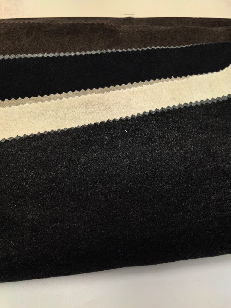 Classic Mélange Brushed Fleece Heavyweight Fabric — Style 25035 2 Textured fabric with black and white stripes